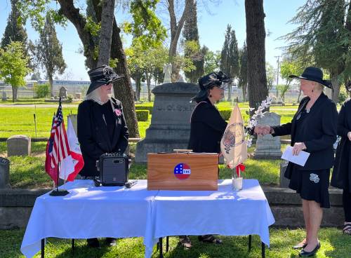 Three women standing and handshaking in an event